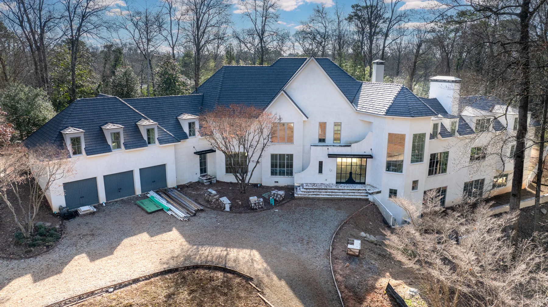 Professional exterior photograph showing the complete roofline of the West Paces property