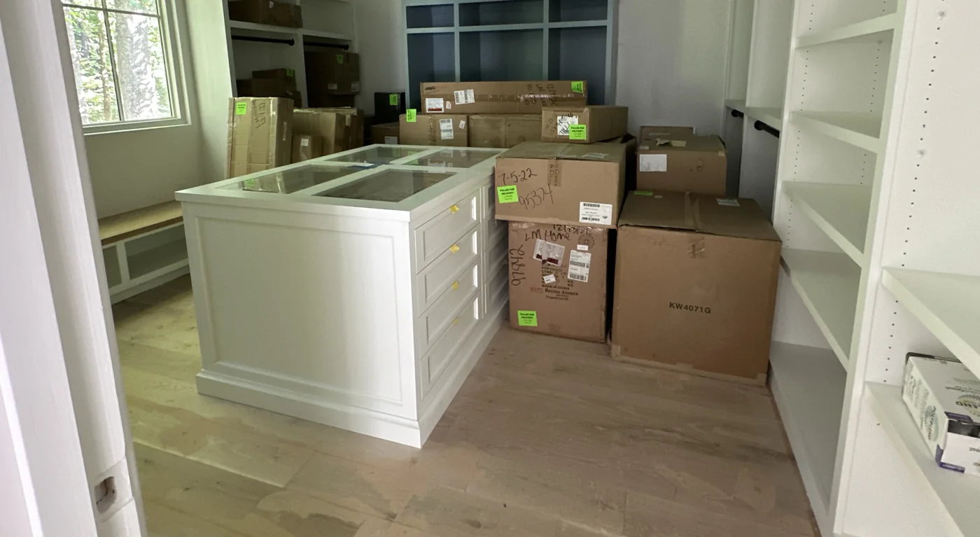 Boxed appliances and fixtures stacked inside the home